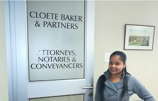 Client standing next to the logo on the door "Cloete, Baker & Partners. Attorneys, notaries & conveyancers"
